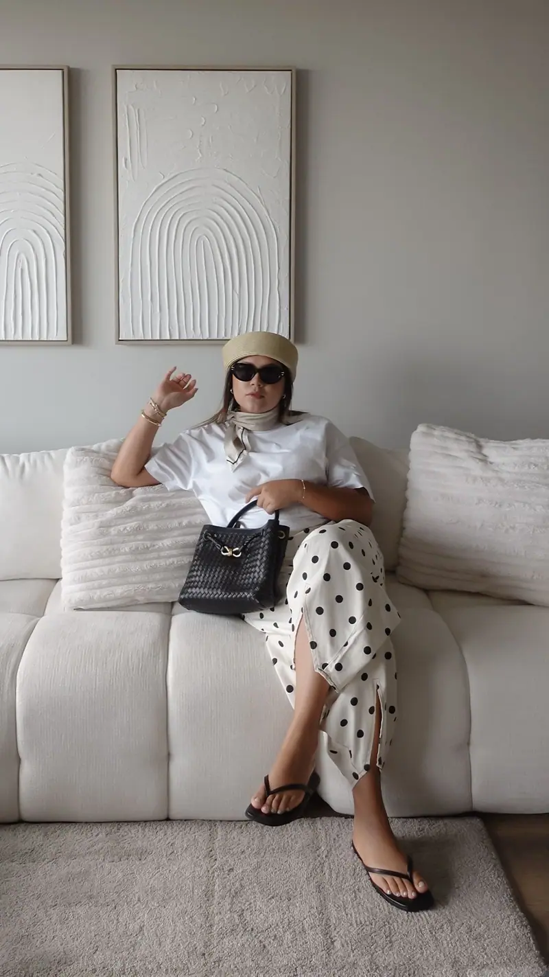 Polaroid-style photo of Alejandra on a cream sofa